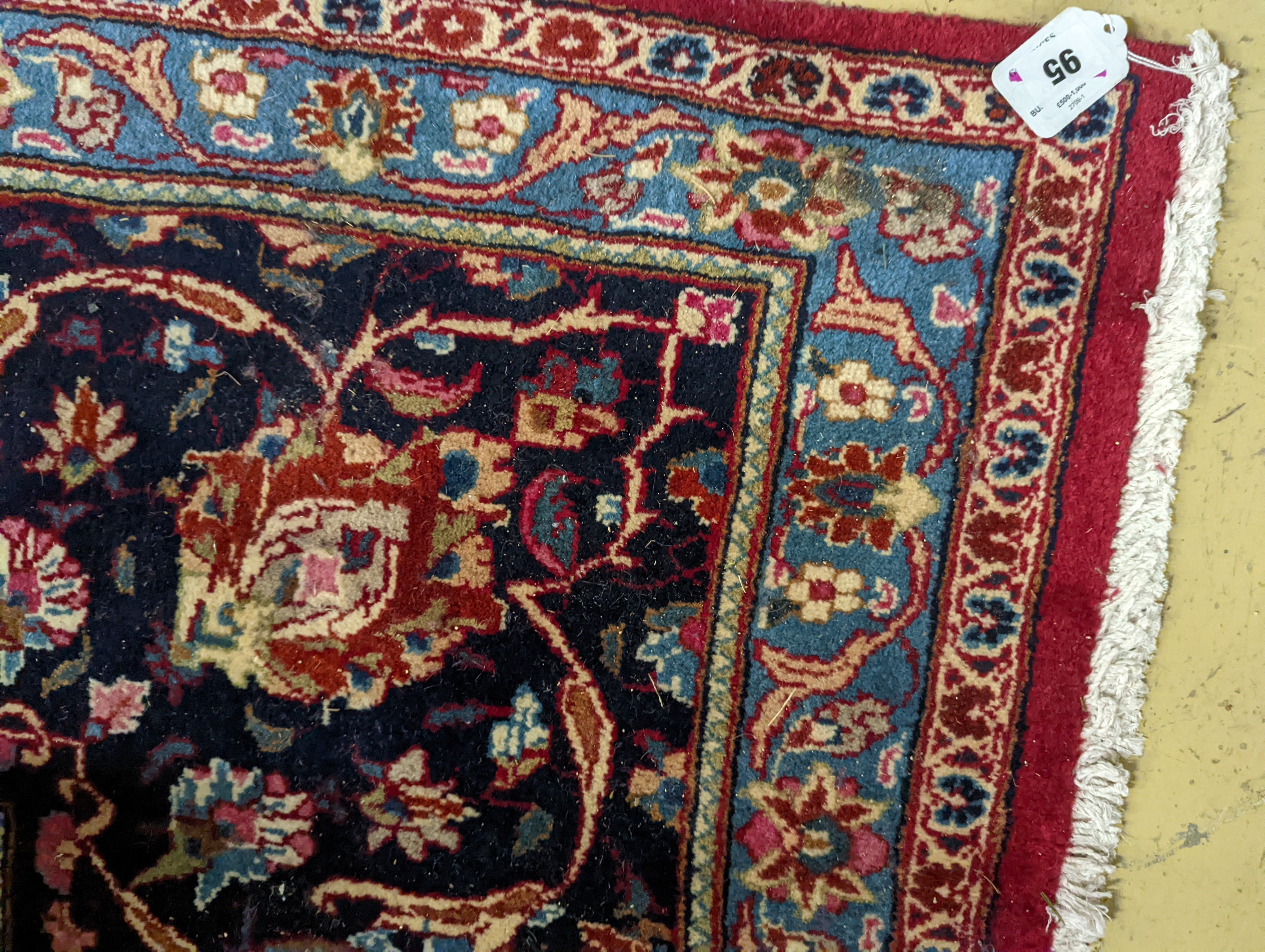 A Kashan burgundy ground carpet, 380 x 300cm